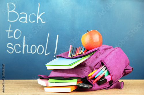 Purple backpack with school supplies