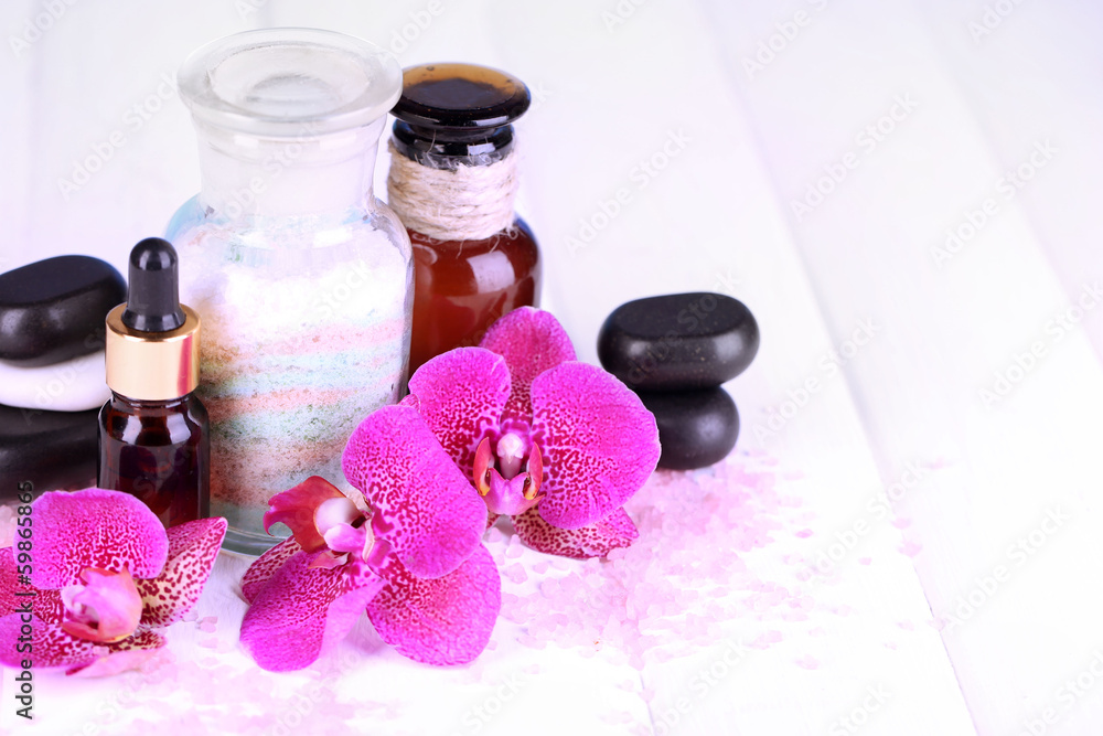 Beautiful spa setting with orchid on white wooden table Beautiful spa setting with orchid on white wooden table