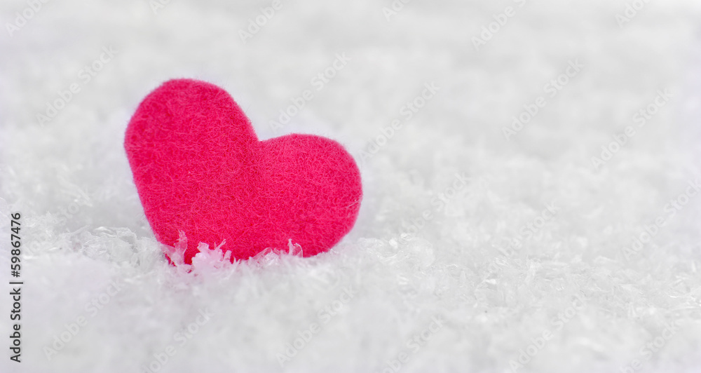 Fototapeta premium Little felt heart on snowy background