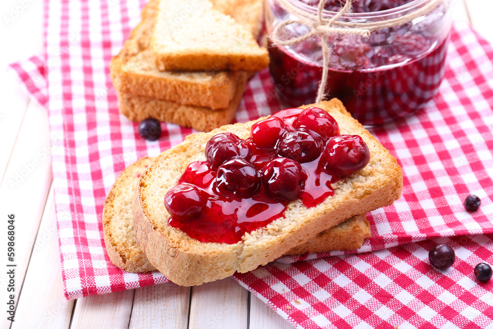 Delicious toast with jam on table close-up