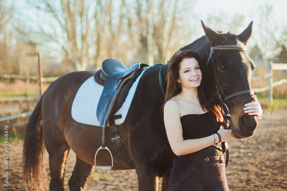 Obraz premium Young woman with a horse on nature