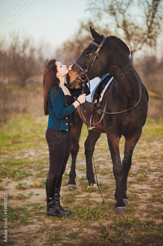 Young woman with a horse on nature © Maxim P