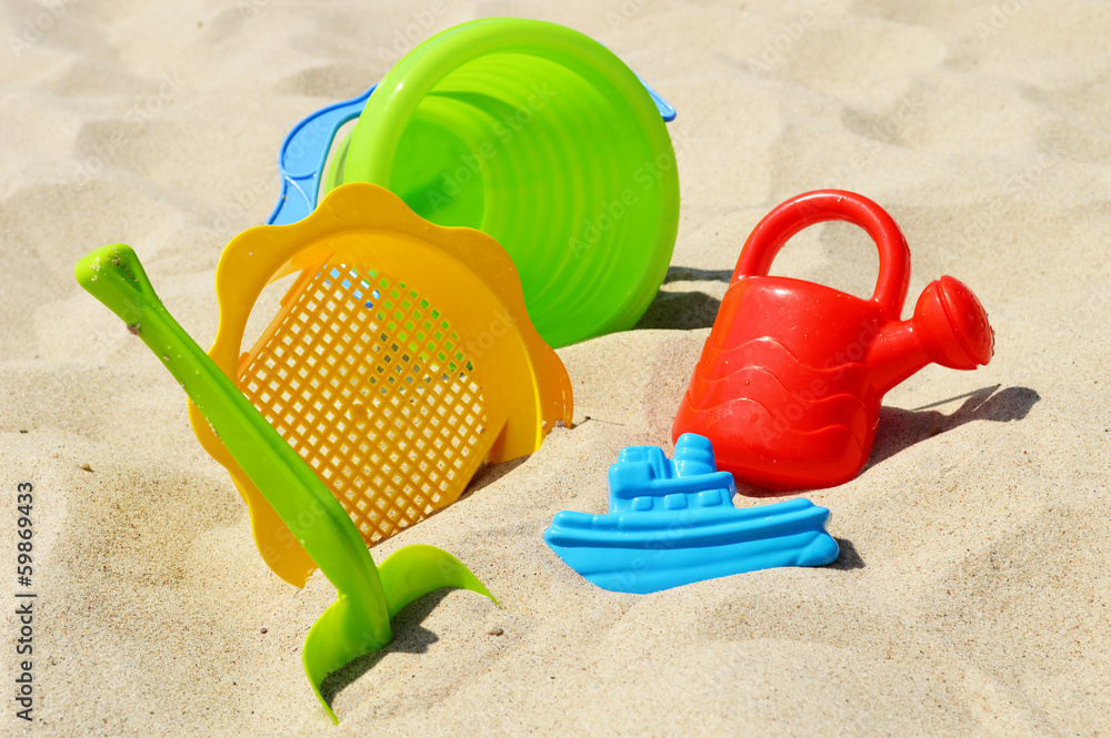 Plastic children toys on the sand beach Plastic children toys on the sand beach