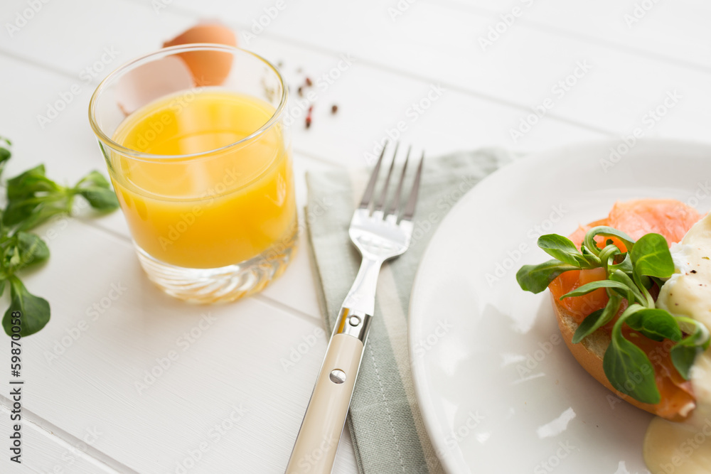 Breakfast with fresh orange juice, salad and poached eggs Breakfast with fresh orange juice, salad and poached eggs