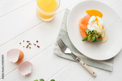 Breakfast with fresh orange juice, salad and poached eggs