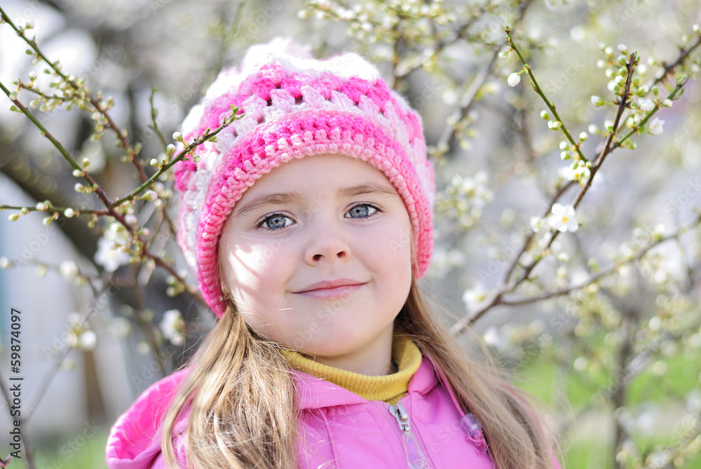 beautiful little girl near a flowering tree beautiful little girl near a flowering tree
