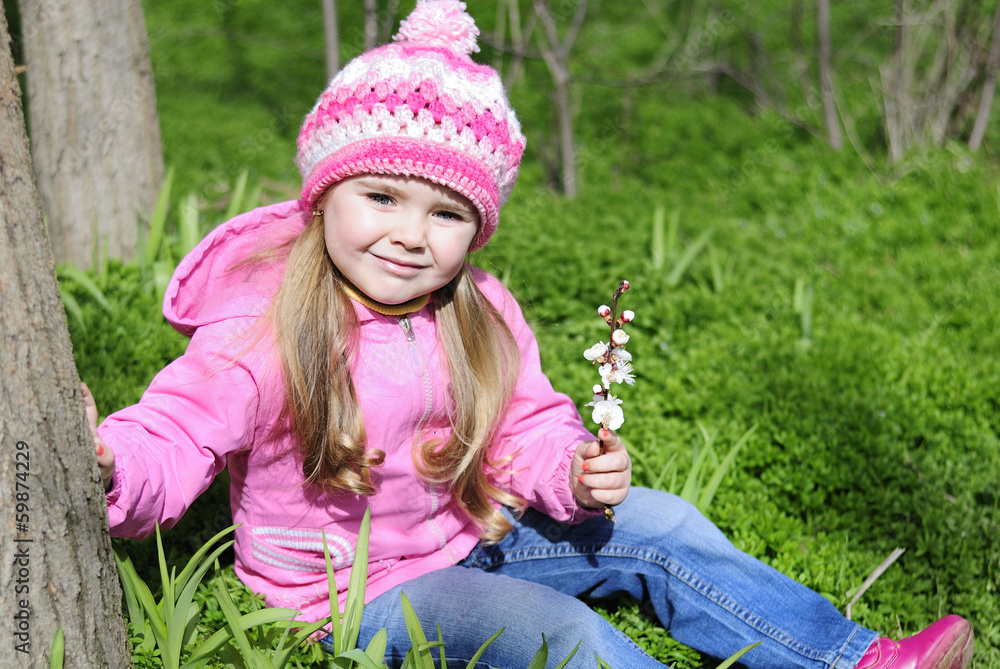 beautiful little girl near a flowering tree beautiful little girl near a flowering tree