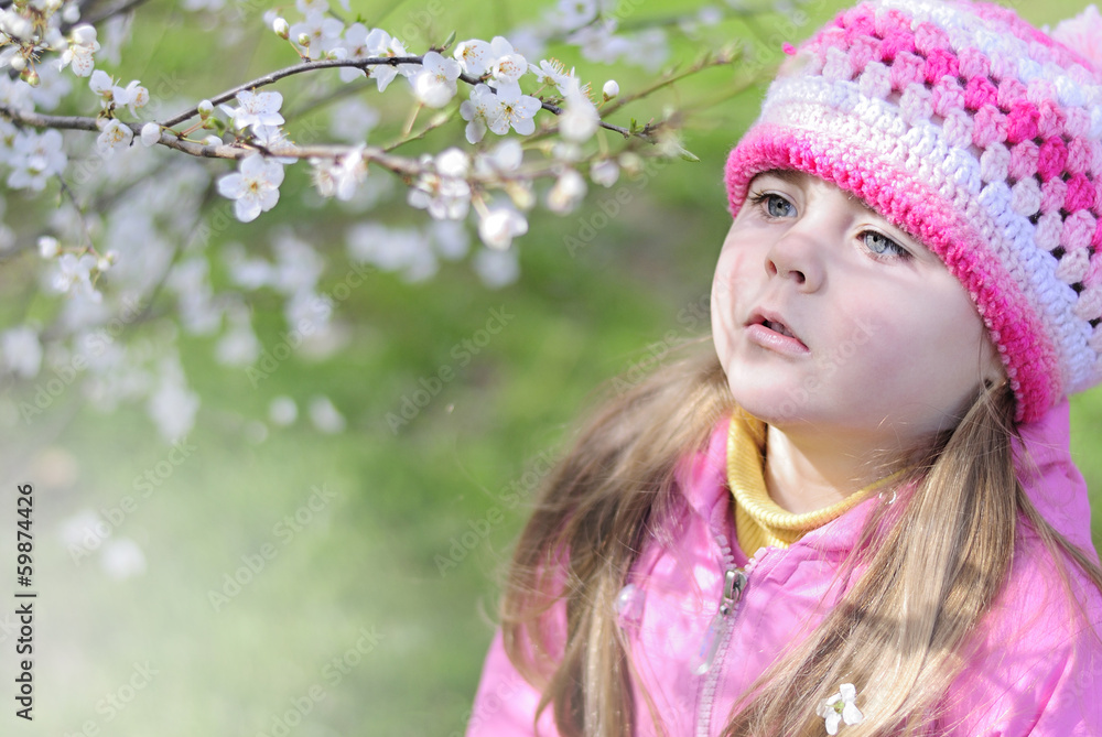 beautiful little girl near a flowering tree beautiful little girl near a flowering tree