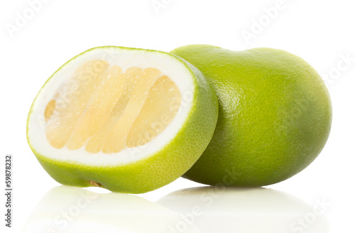 green grapefruit and slices on white background
