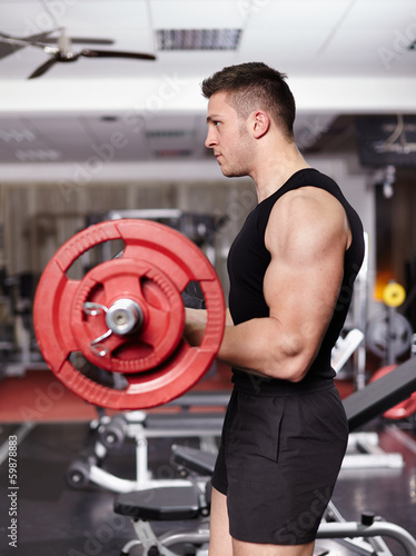 Athletic man working with barbell