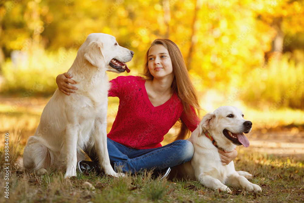Beautiful woman and her dog posing in autumn park Beautiful woman and her dog posing in autumn park