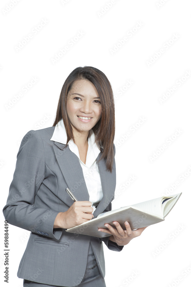 Business woman asian attractive standing using a pen writing dia Business woman asian attractive standing using a pen writing dia