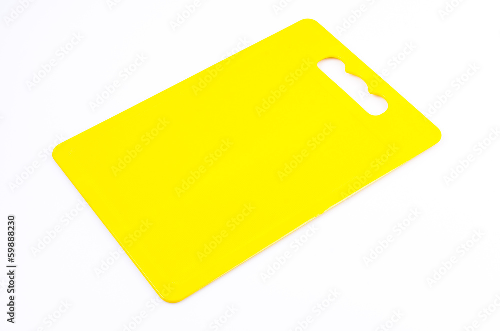 Yellow plastic cutting board on isolated white background Yellow plastic cutting board on isolated white background