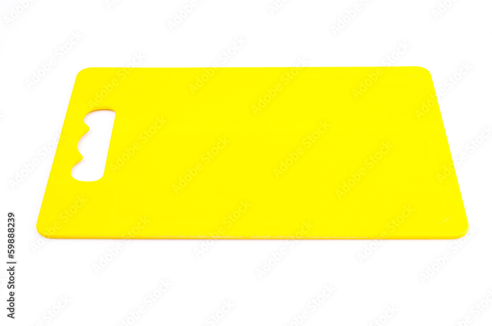 Yellow plastic cutting board on isolated white background Yellow plastic cutting board on isolated white background