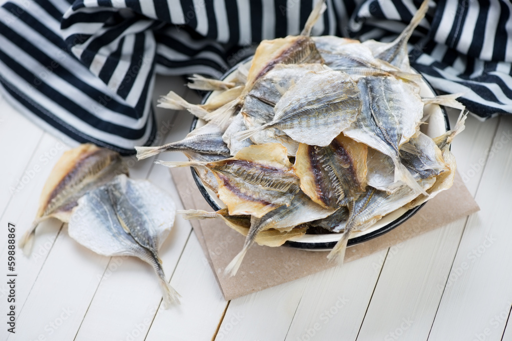 Bowl full of dried scad and striped sailor suit, horizontal shot