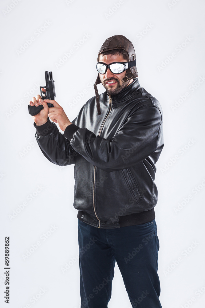 Arrogant young man holding a gun pointed upwards Arrogant young man holding a gun pointed upwards
