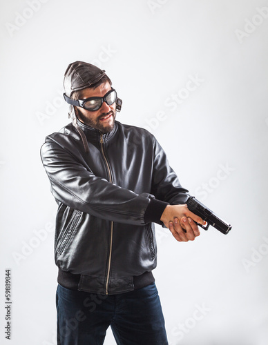 Young man holding a gun with both hands