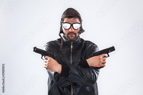 Serious man holding two guns in his hands