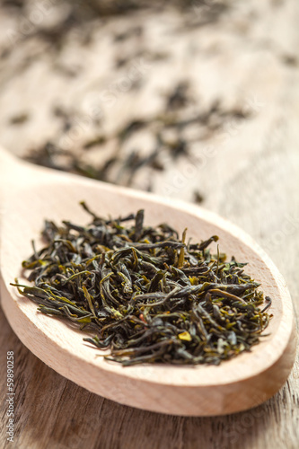 Spoon with green tea herbs