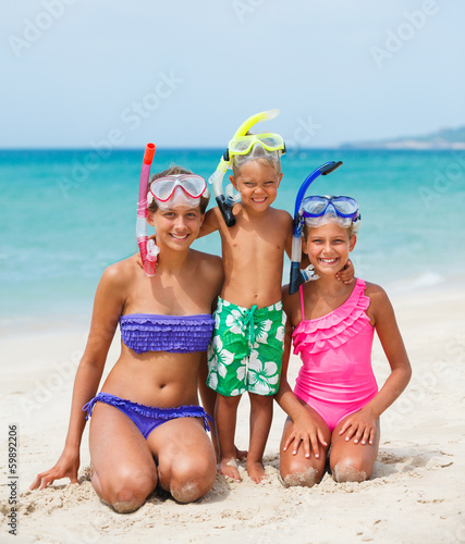 three happy children on beach...