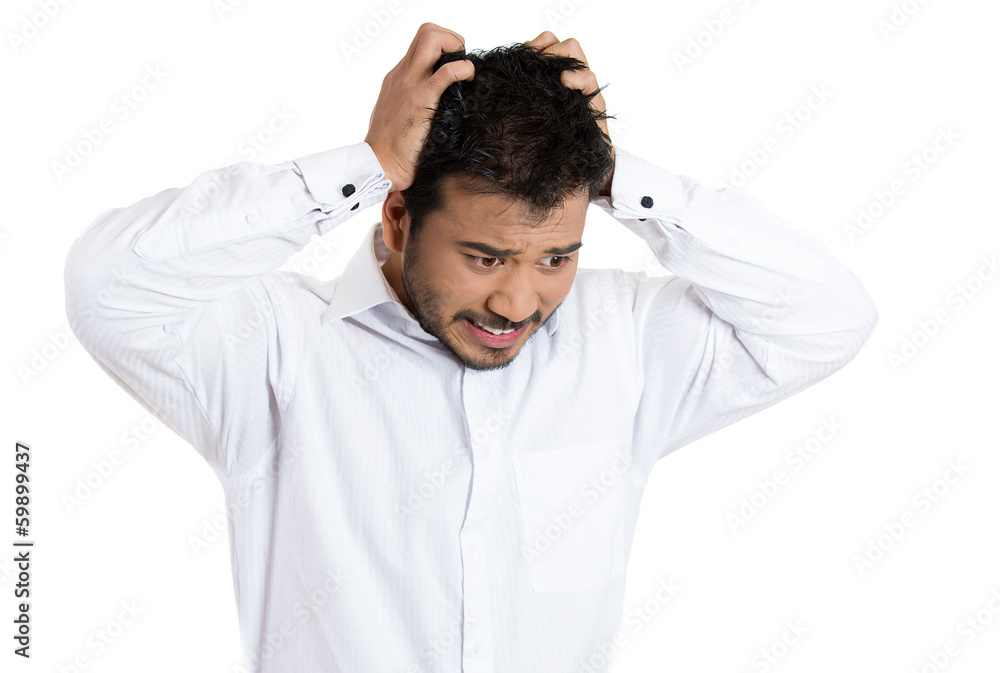 Overwhelmed young stressed man pulling out his hair Overwhelmed young stressed man pulling out his hair