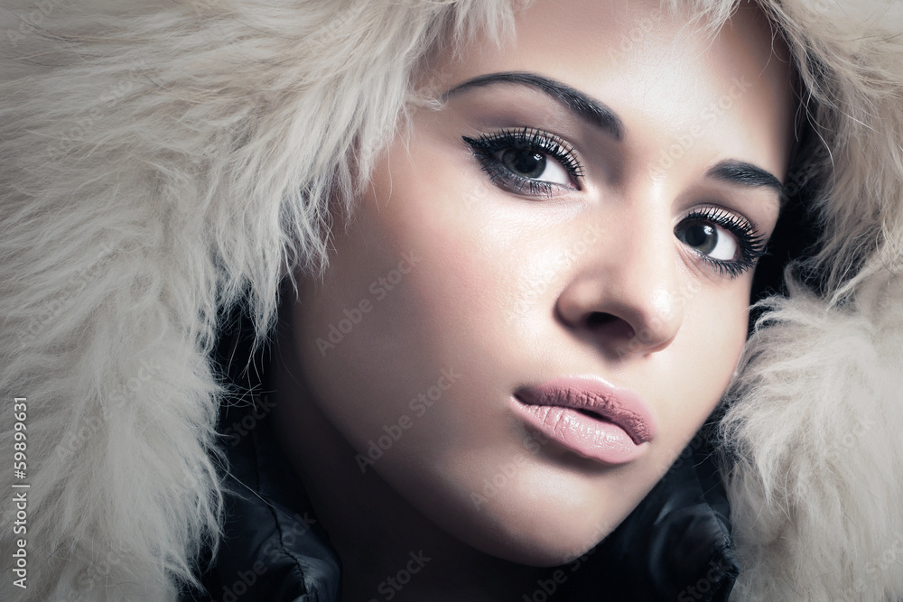 Young Beautiful Woman in Fur Hood. Winter Style