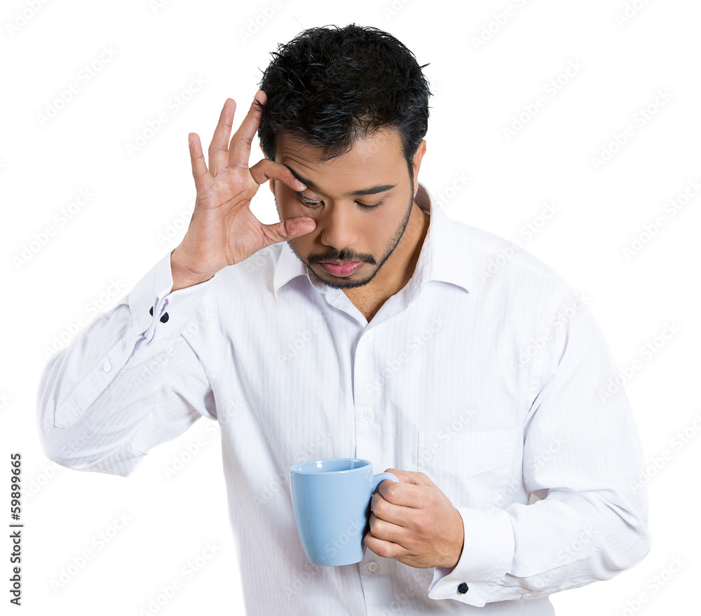Sleepy business man holding cup of coffee, trying to stay awake Sleepy business man holding cup of coffee, trying to stay awake