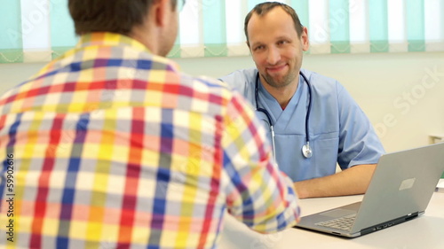 Doctor telling good news to happy female patient