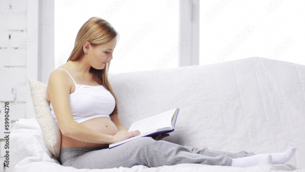 pregnant woman reading book at home pregnant woman reading book at home