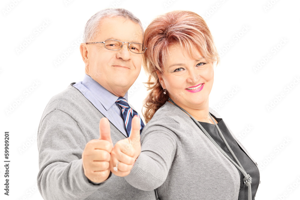 Smiling mature couple giving thumbs up Smiling mature couple giving thumbs up