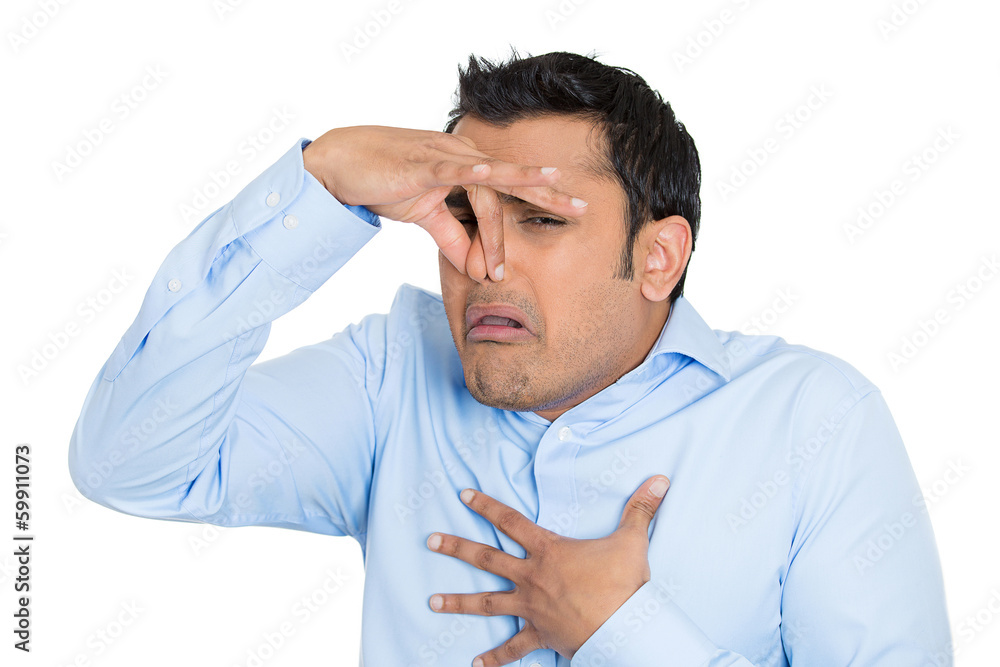 Man pinches his nose, something stinks, very bad smell Man pinches his nose, something stinks, very bad smell
