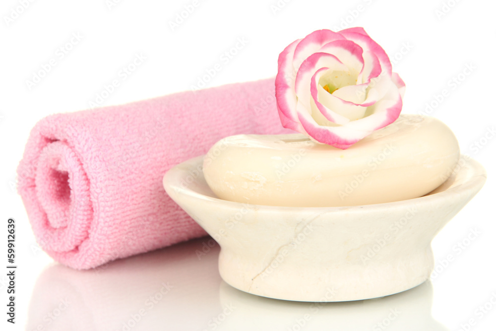 Rolled pink towel, soap bar and beautiful flower isolated Rolled pink towel, soap bar and beautiful flower isolated