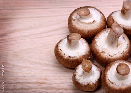 Mushrooms over wooden background. Baby Bella