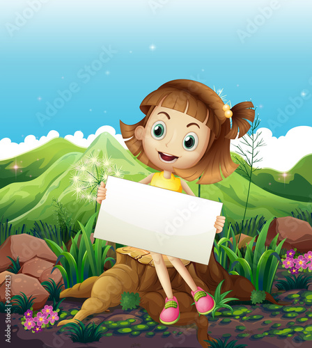 A happy girl sitting above the stump while holding an empty sign