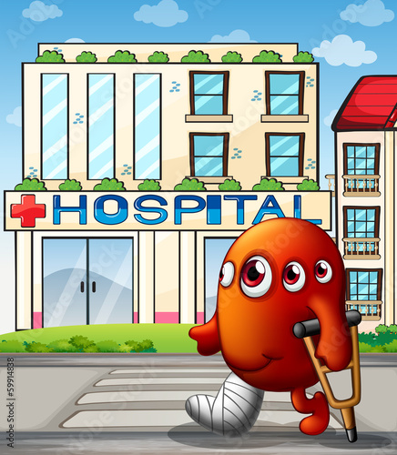 A multi-eyed monster in front of the hospital building