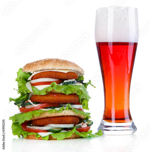 Huge burger and glass cold beer, isolated on white