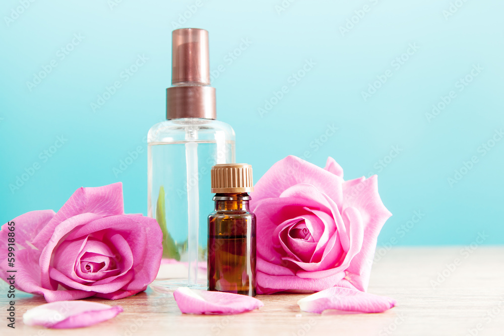 Bottle with aromatic oil and pink rose Bottle with aromatic oil and pink rose