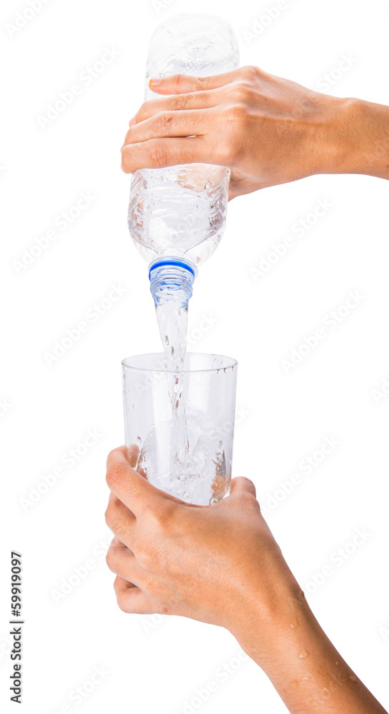 Female hands pouring water into a glass Female hands pouring water into a glass
