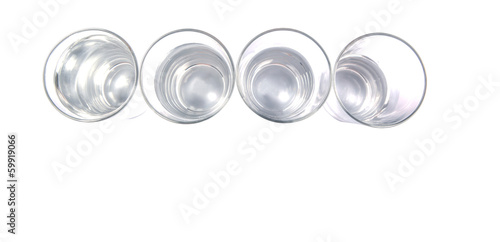 Water filled glasses over white background