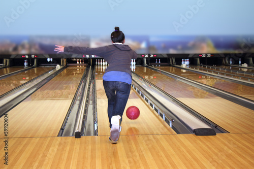 Young girl playing bowling photo