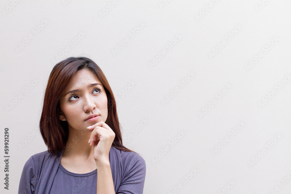 thinking woman, facing upward on plain background thinking woman, facing upward on plain background