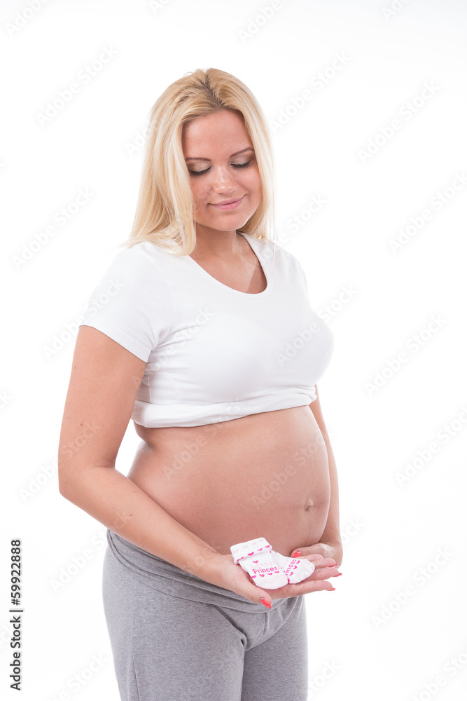 Pregnant woman holding baby socks for baby girl Pregnant woman holding baby socks for baby girl