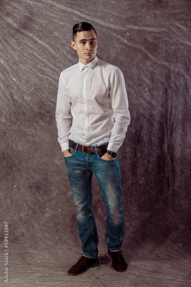 full length portrait of a casual young man standing with both full length portrait of a casual young man standing with both