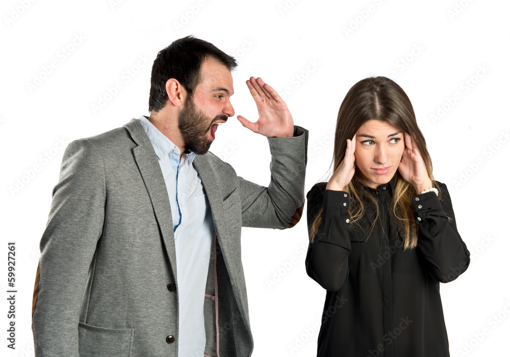 Businessman screaming at his girlfriend over white background Businessman screaming at his girlfriend over white background