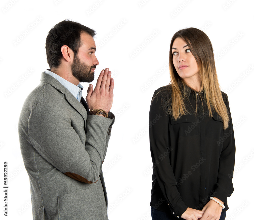 Men pleading at his girlfriend over white background Men pleading at his girlfriend over white background