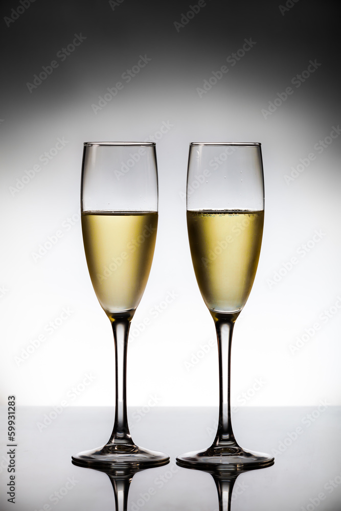 empty glasses of champagne and one being filled empty glasses of champagne and one being filled
