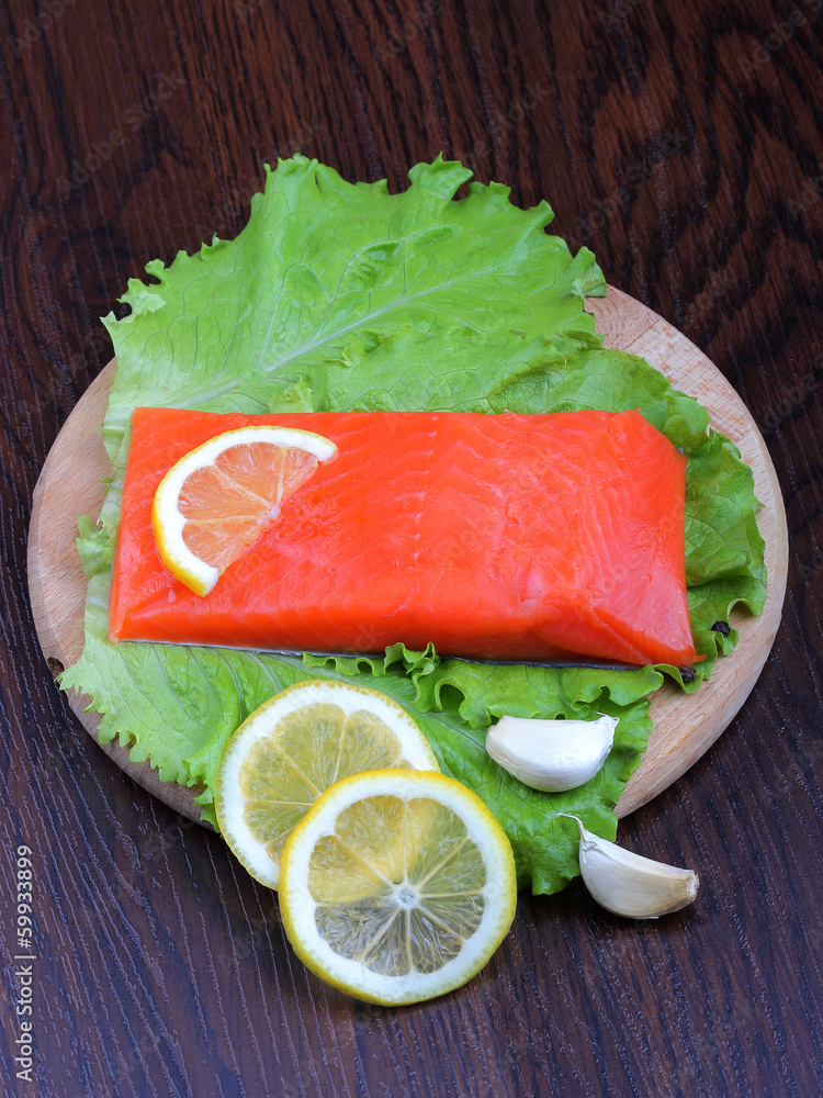 Trout fillet with lemon, garlic and lattuces leaves Trout fillet with lemon, garlic and lattuces leaves