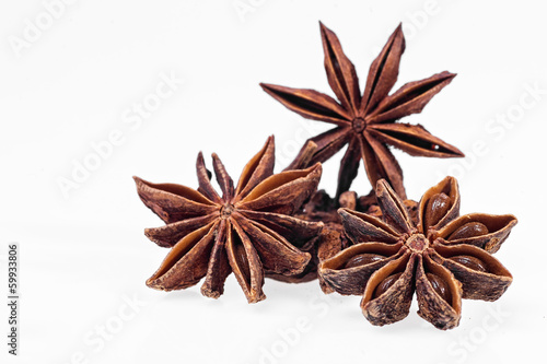 Cinnamon, anise and cloves on white background