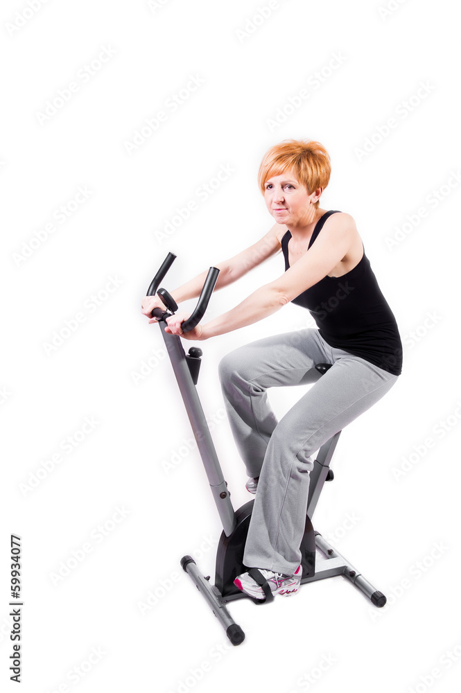 Woman doing sports on exercise bike Woman doing sports on exercise bike