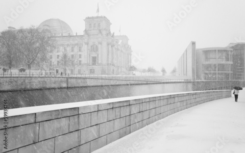 Winter in Berlin with walking People and The Reichstag building